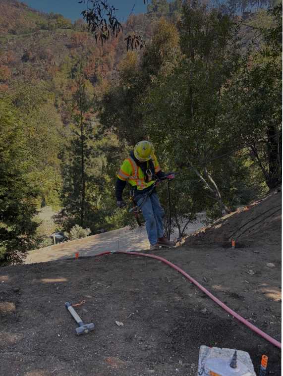 Crew repairing a mountain road after the 2025 Palisades fire